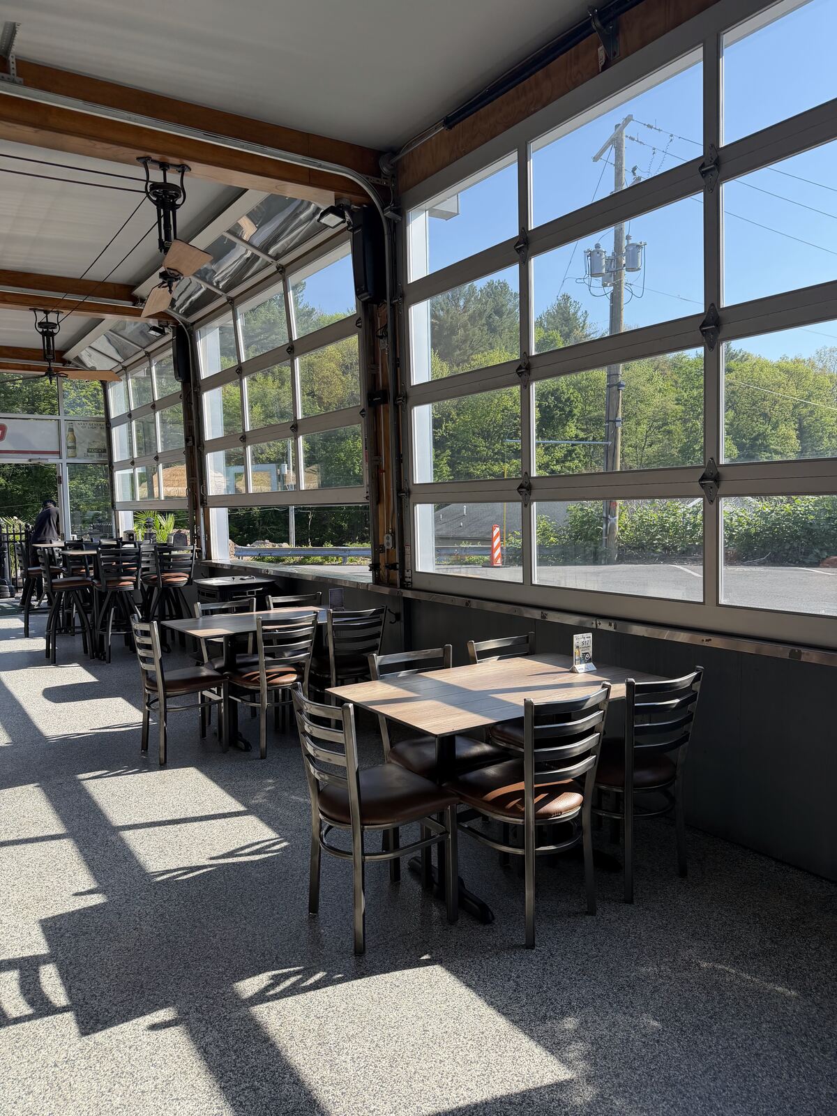 Morning light through the glass garage doors of the four-season patio at The Coney Island in Pottsville, PA.