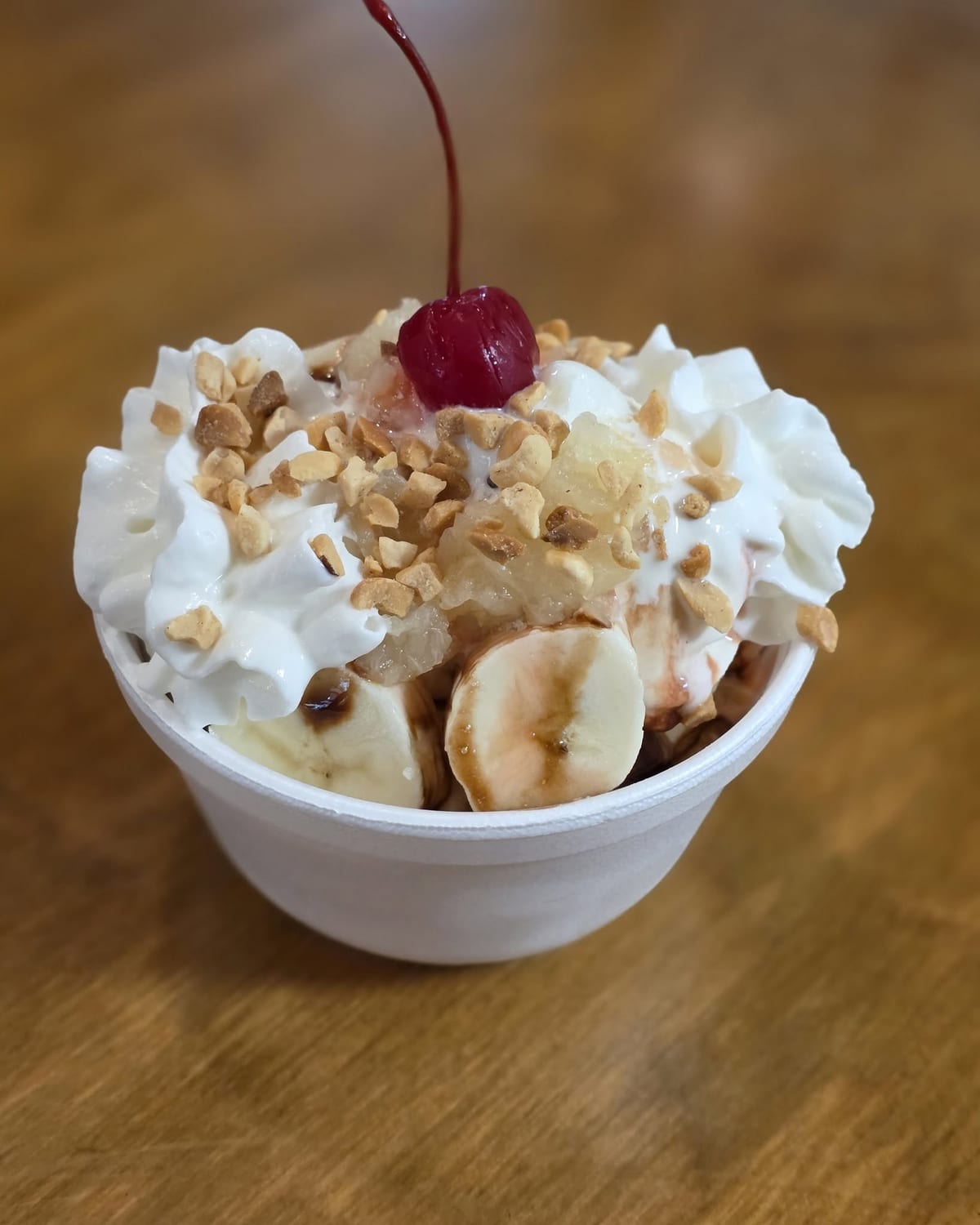 A banana split sundae with fresh banana, peanuts, whipped cream, and a cherry at The Coney Island in Pottsville, PA.