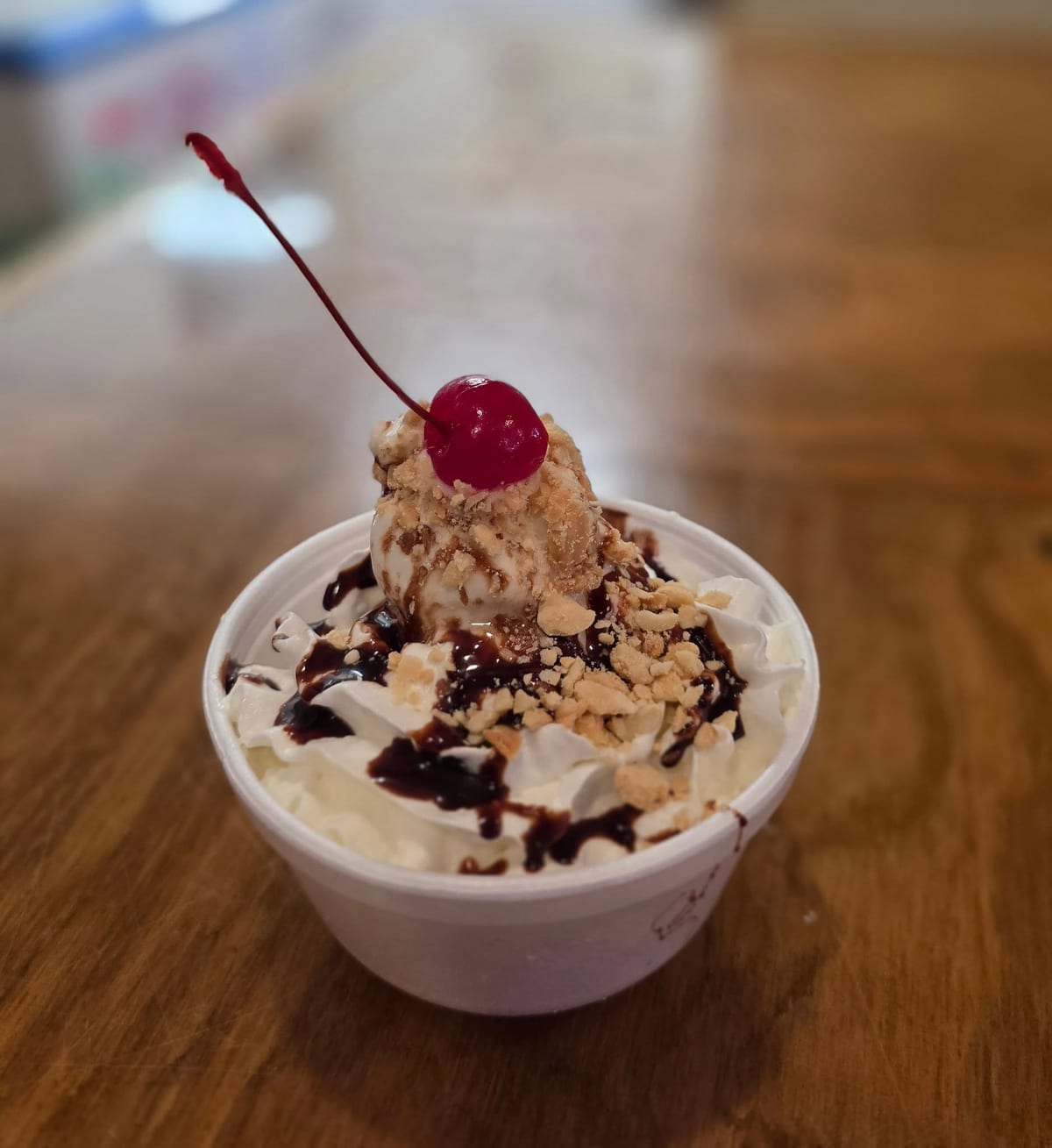 A hot fudge sundae with whipped cream, chopped peanuts, and a cherry at The Coney Island in Pottsville, PA.