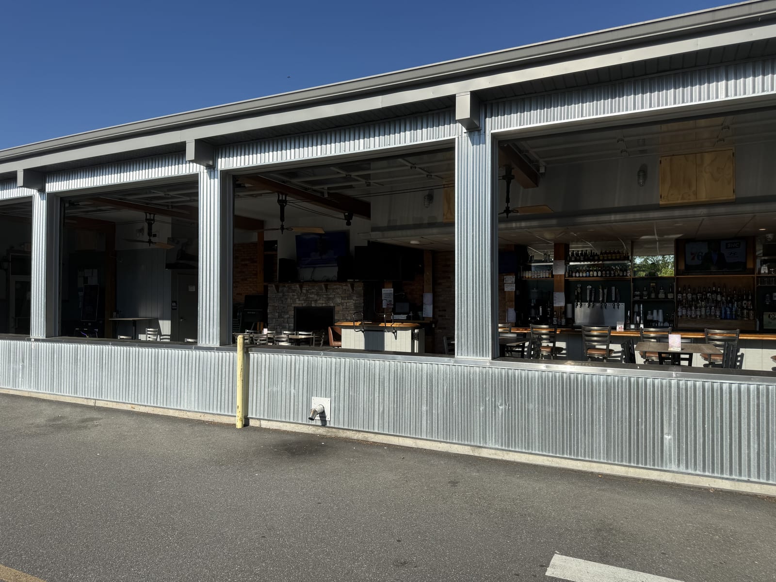 The four-season patio at The Coney Island in Pottsville, PA, with the roll-up glass garage doors rolled up for warm-weather open-air dining.