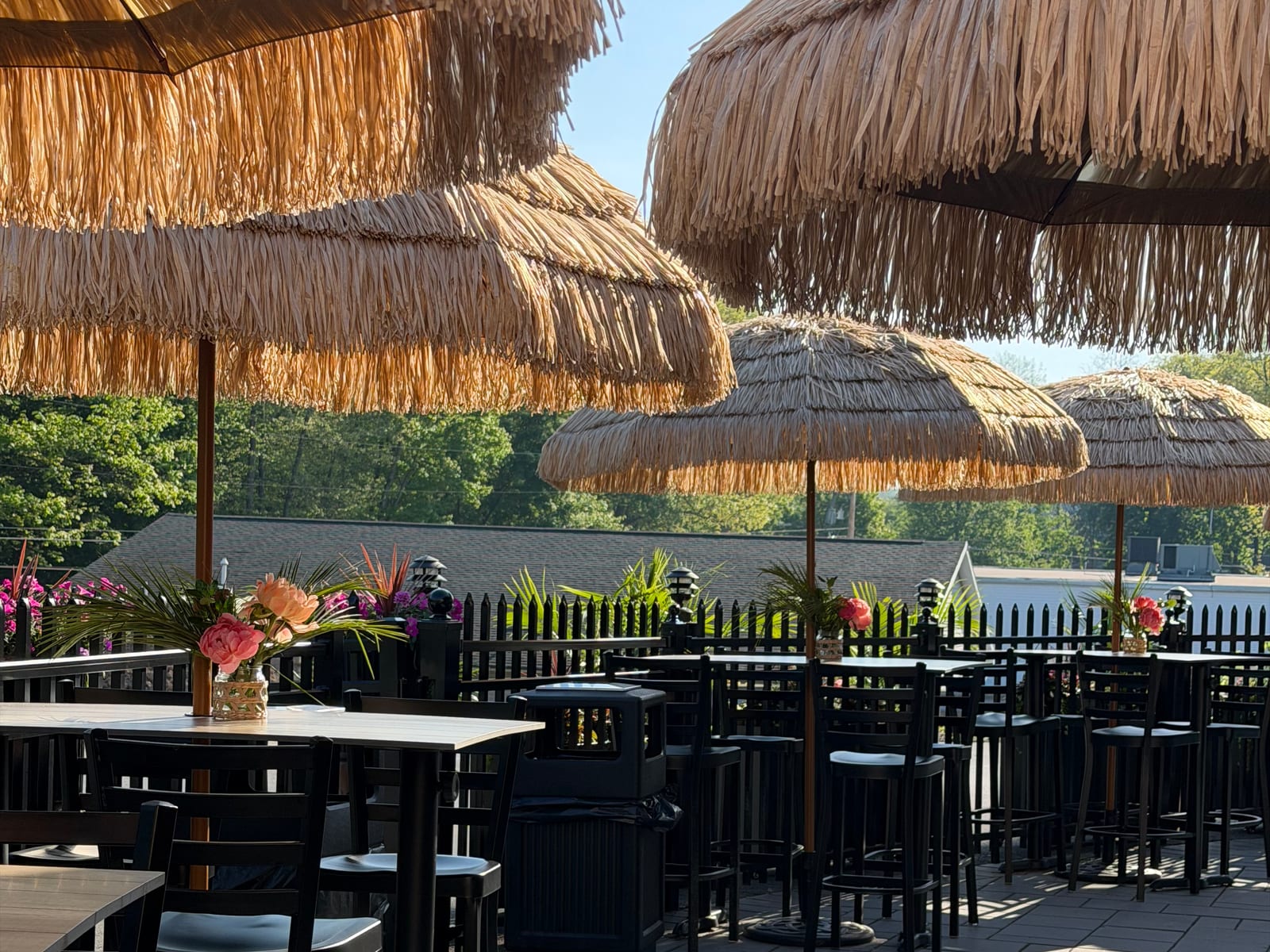 Thatched umbrellas over tables at the seasonal tiki bar at The Coney Island in Pottsville, PA.